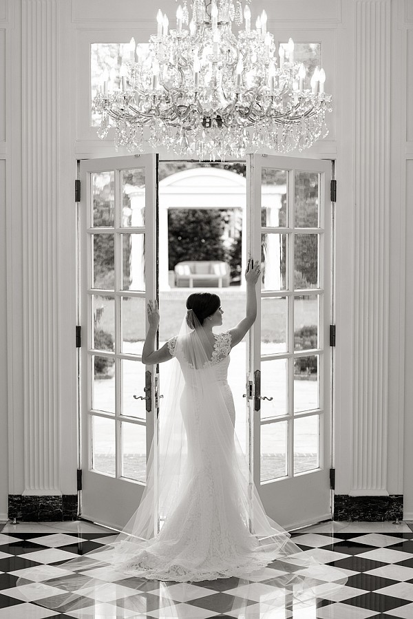 duke-mansion-chandelier-bridal-portrait-charlotte.jpg Beautiful bride posing in doorway at Duke Mansion in Charlotte NC